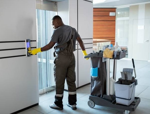 Magic Hygiene technician servicing equipment in a commercial building